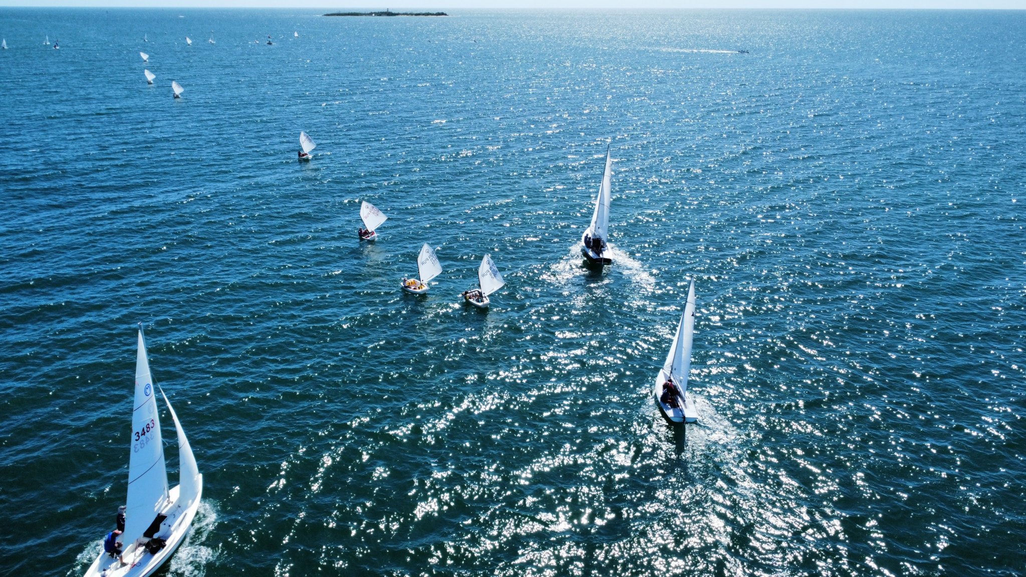 Aerial view of regatta with multiple sailboats