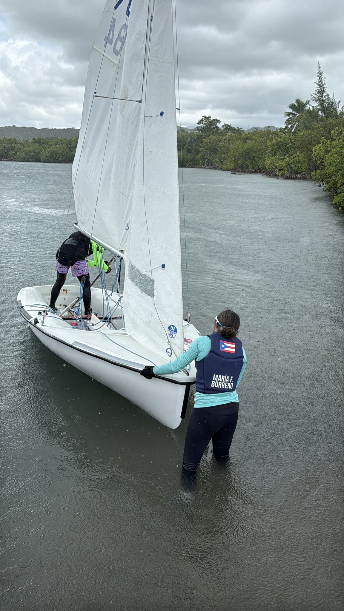 María wearing her PUR sailing vest at the dock